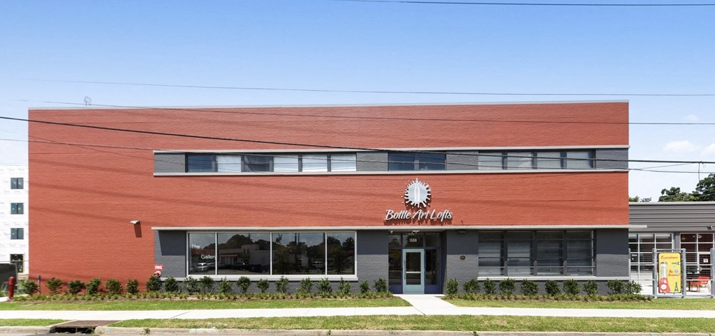 a red building with a sun logo on the side of it