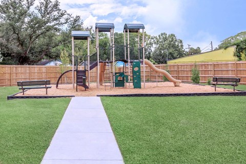 A playground with a slide, swings, and a climbing frame.