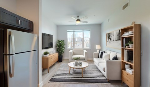A modern kitchen with a refrigerator, a dining table with chairs, and a living area with a sofa.