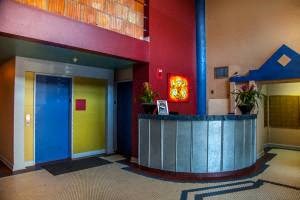 the lobby of a hotel with a reception desk and a blue door