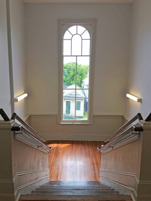 A staircase with a window above it.