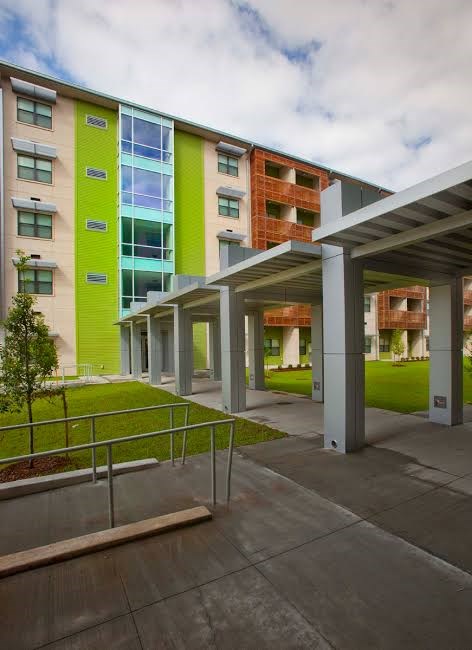 A modern building with a green and yellow facade.