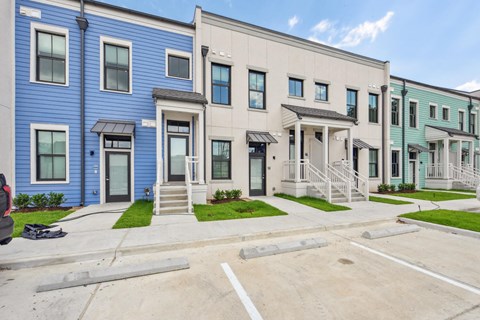 A row of townhouses with blue and beige exteriors.