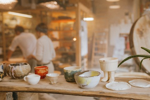 a selection of cups and plates on a table in a shop
