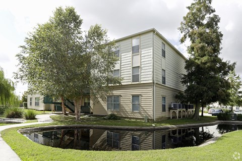 A building with a pool in front of it.