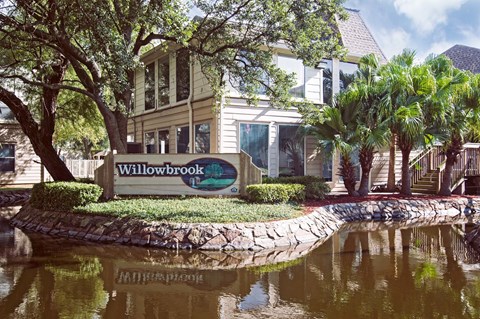 A sign that says Willowbrook in front of a building.