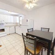 a kitchen and dining room with a table and chairs