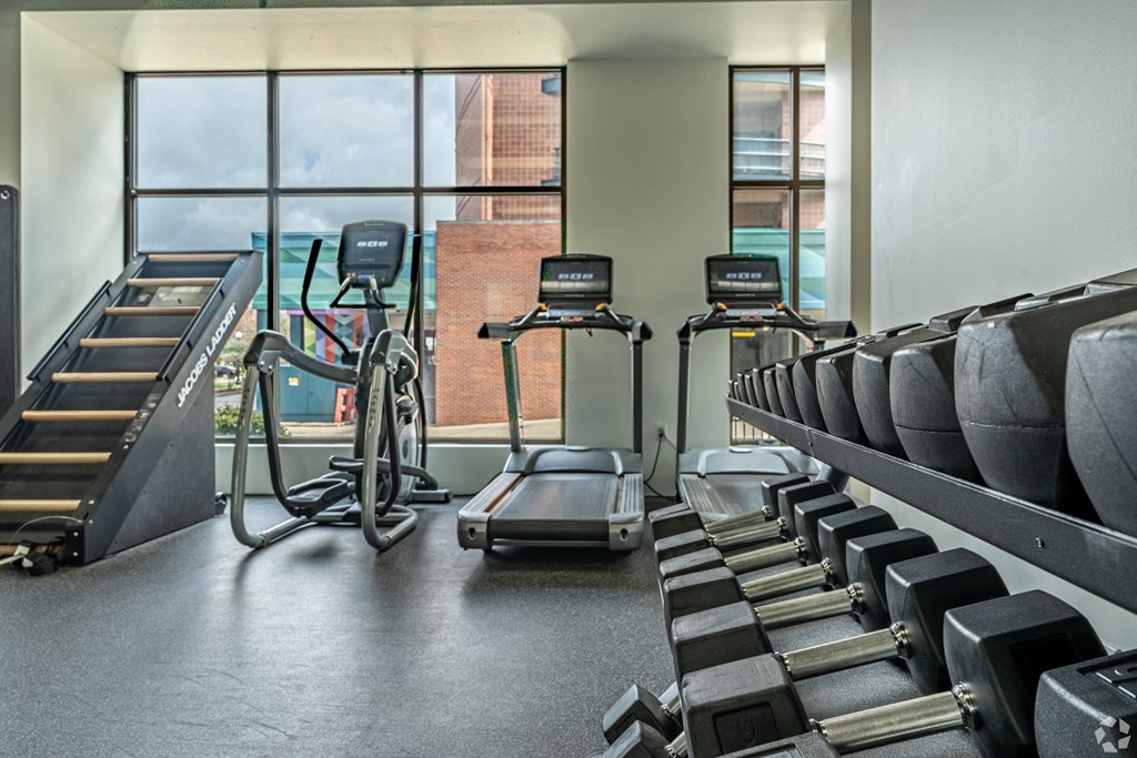 a gym filled with cardio equipment and treadmills