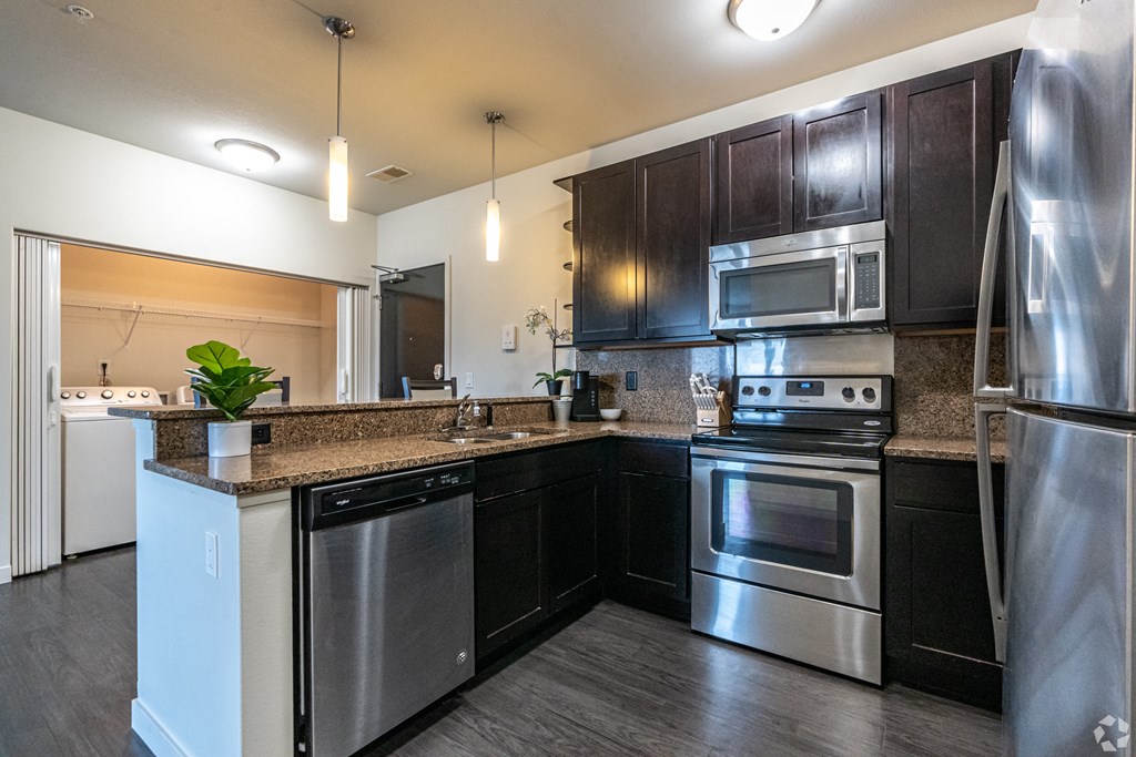 a kitchen with stainless steel appliances and granite counter tops