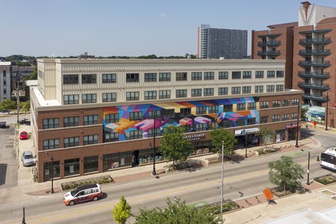 a building with colorful umbrellas on the side of it