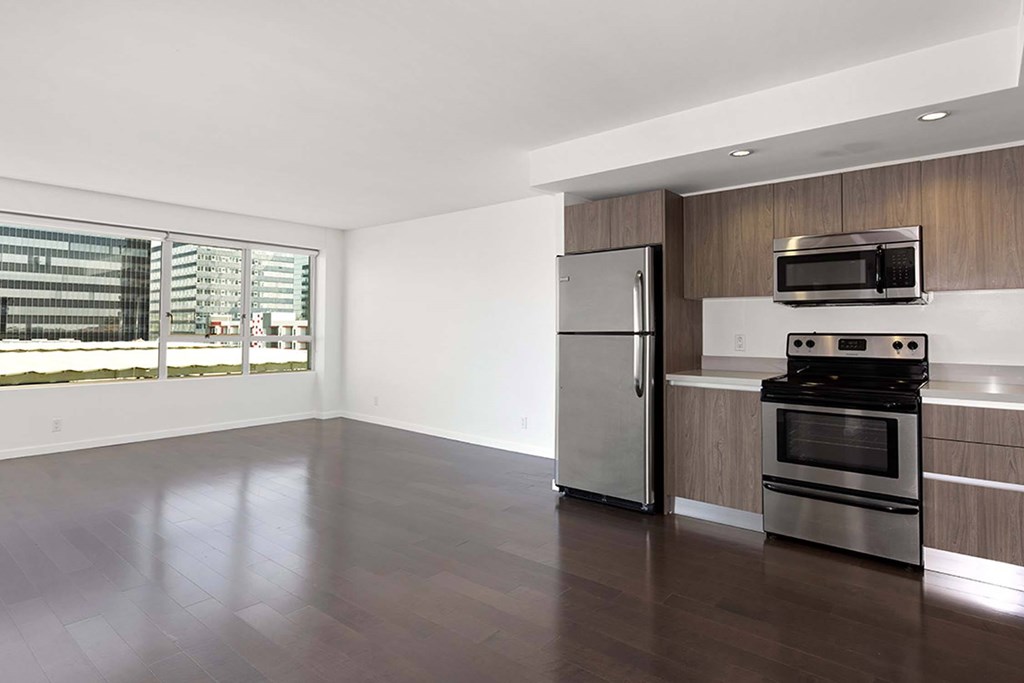 A kitchen with a stainless steel refrigerator and oven.