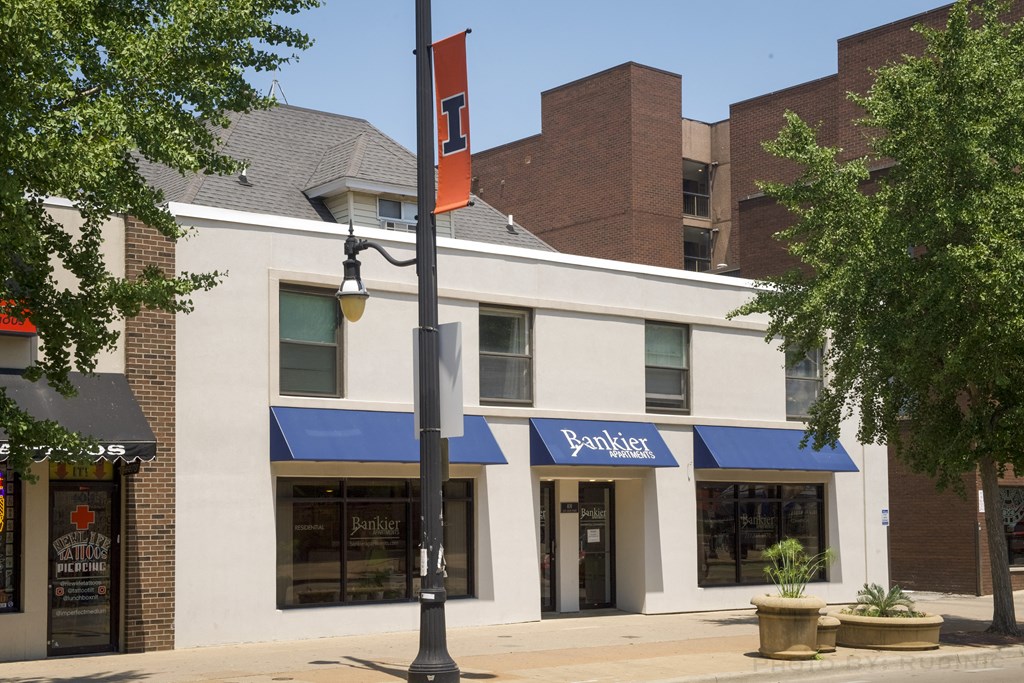 a building with a blue and white awning and a street light in front of it