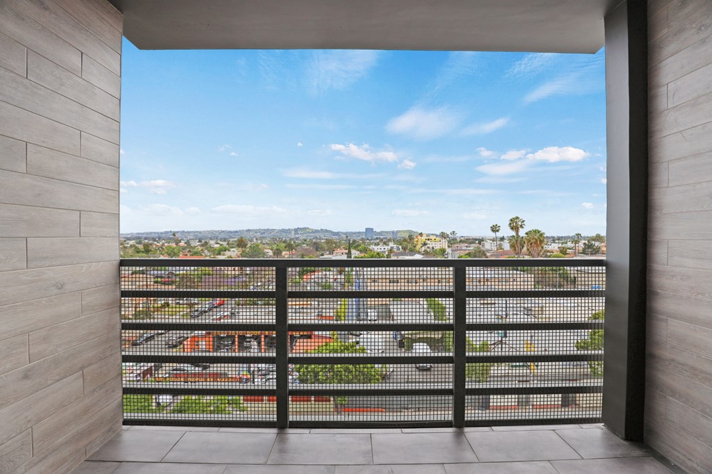 a balcony with a view of the city at The Fairfax Flats Apartments, Los Angeles, CA