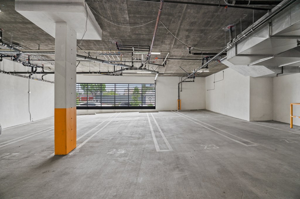 an empty parking lot with a large window in the background at The Fairfax Flats Apartments, California