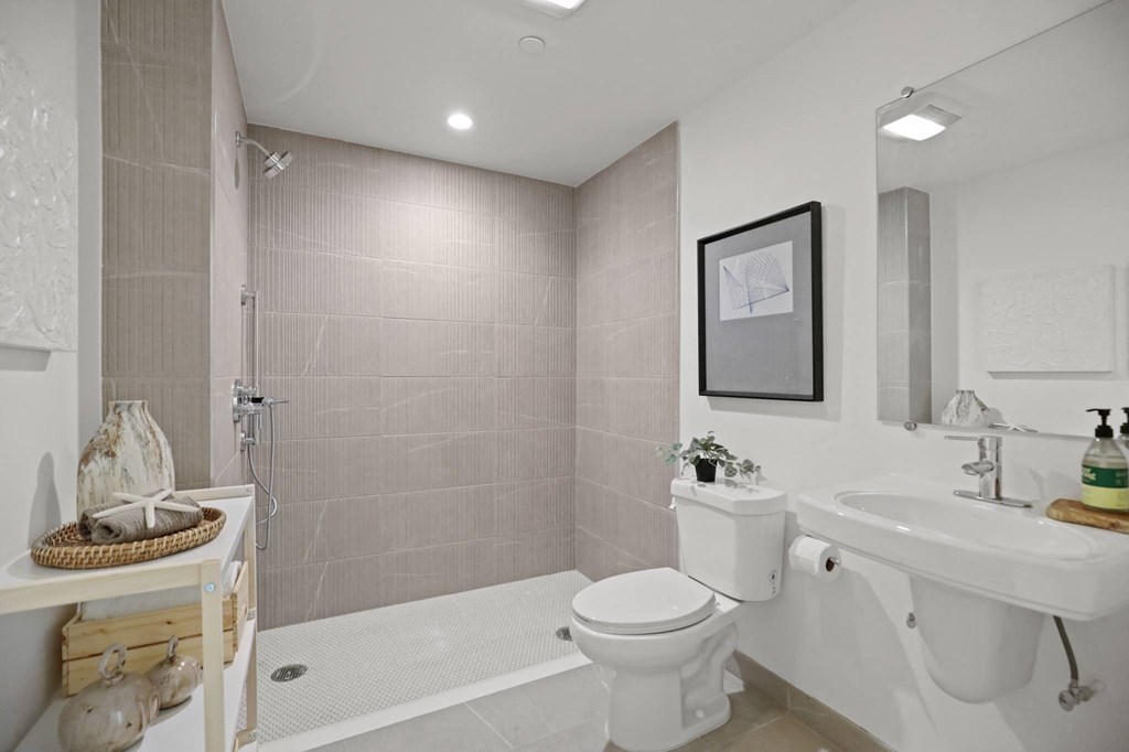 a bathroom with a sink toilet and bathtub at The Fairfax Flats Apartments, California, 90019
