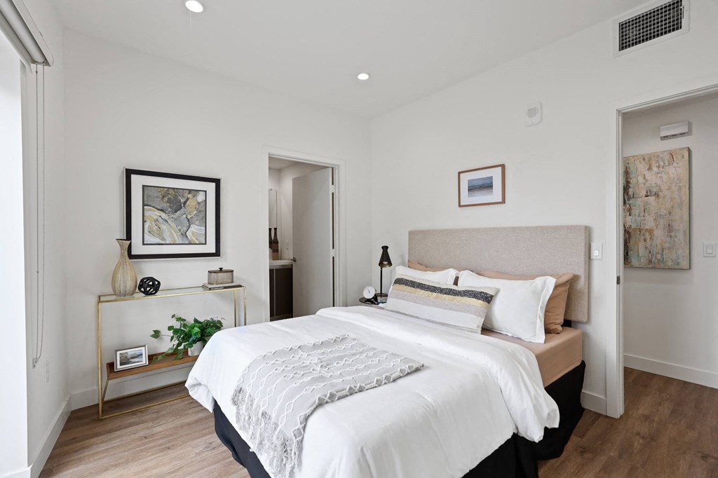 a bedroom with a large bed in a room at The Fairfax Flats Apartments, California
