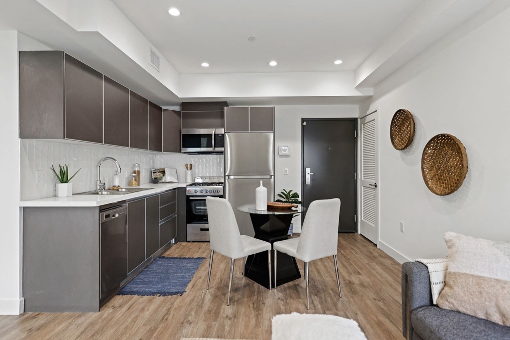 a kitchen and dining area in a 555 waverly unit at The Fairfax Flats Apartments, California