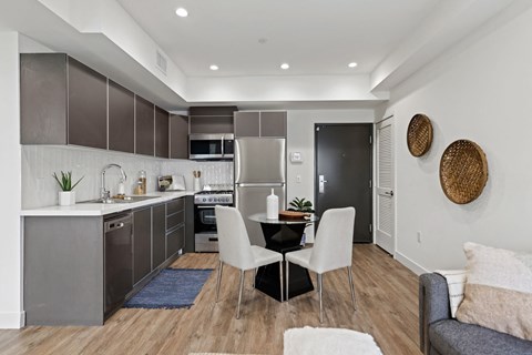 a kitchen and dining room with a table and chairs