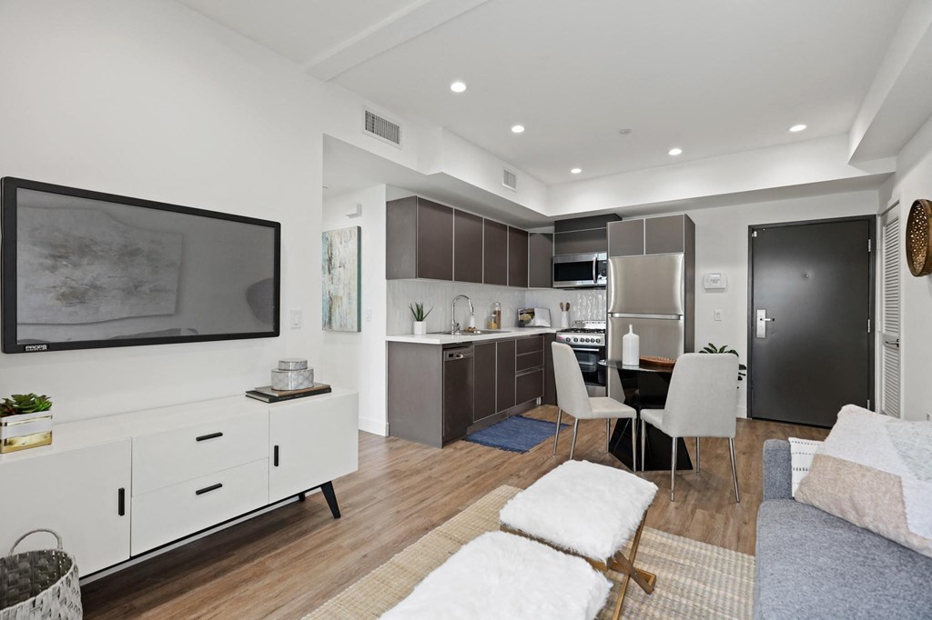 a living room with white walls and hardwood floors at The Fairfax Flats Apartments, Los Angeles, CA