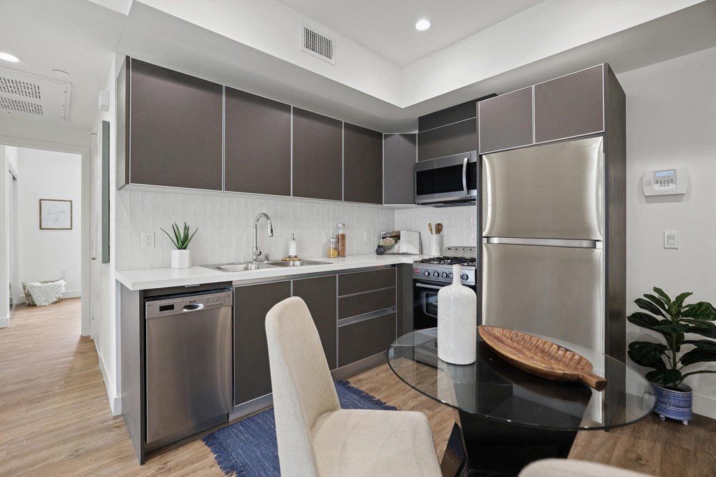 a kitchen and dining area in a 555 waverly unit at The Fairfax Flats Apartments, California, 90019