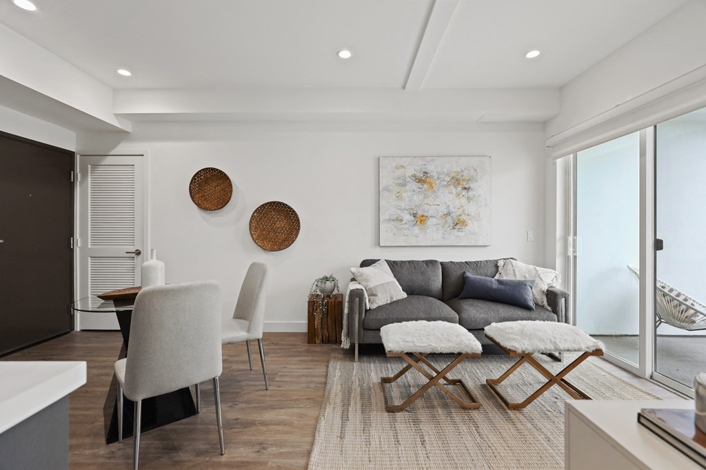 a living room with white walls and a gray couch at The Fairfax Flats Apartments, California