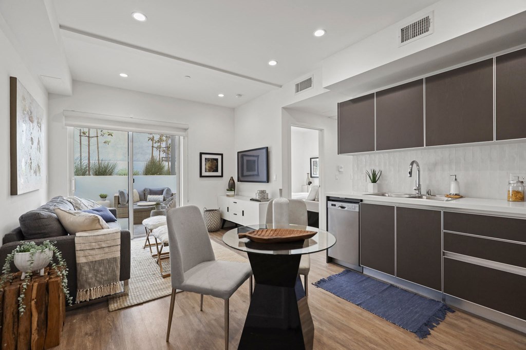 a kitchen and living area in a 555 waverly unit at The Fairfax Flats Apartments, Los Angeles, CA