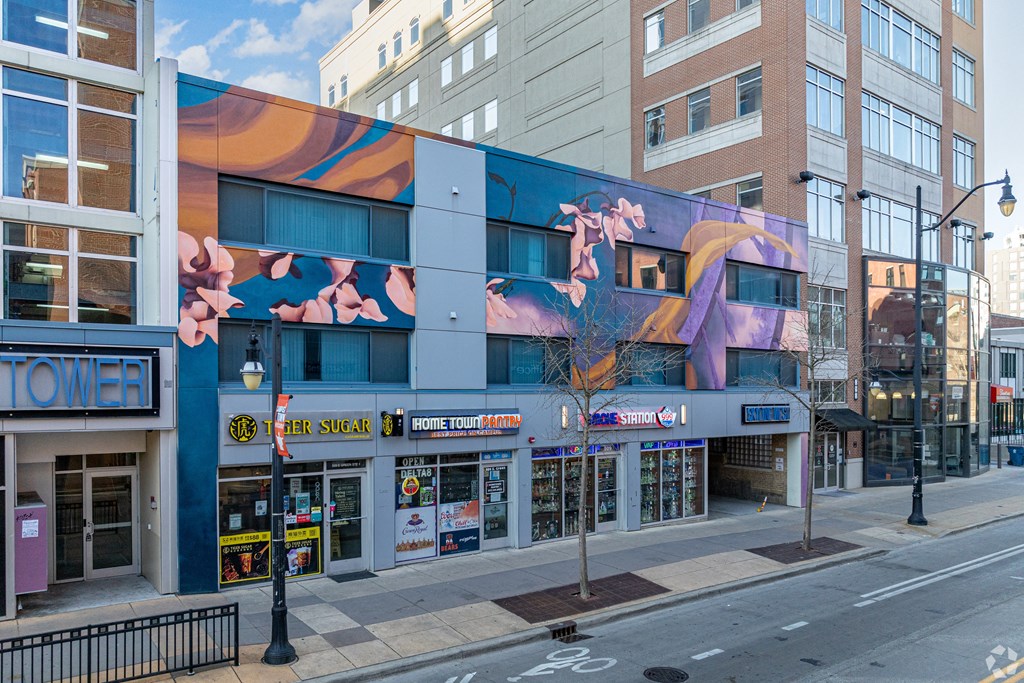 a building with a mural on it on a city street