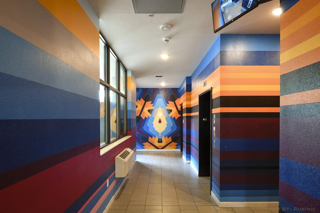 a hallway with a colorful mural on the wall