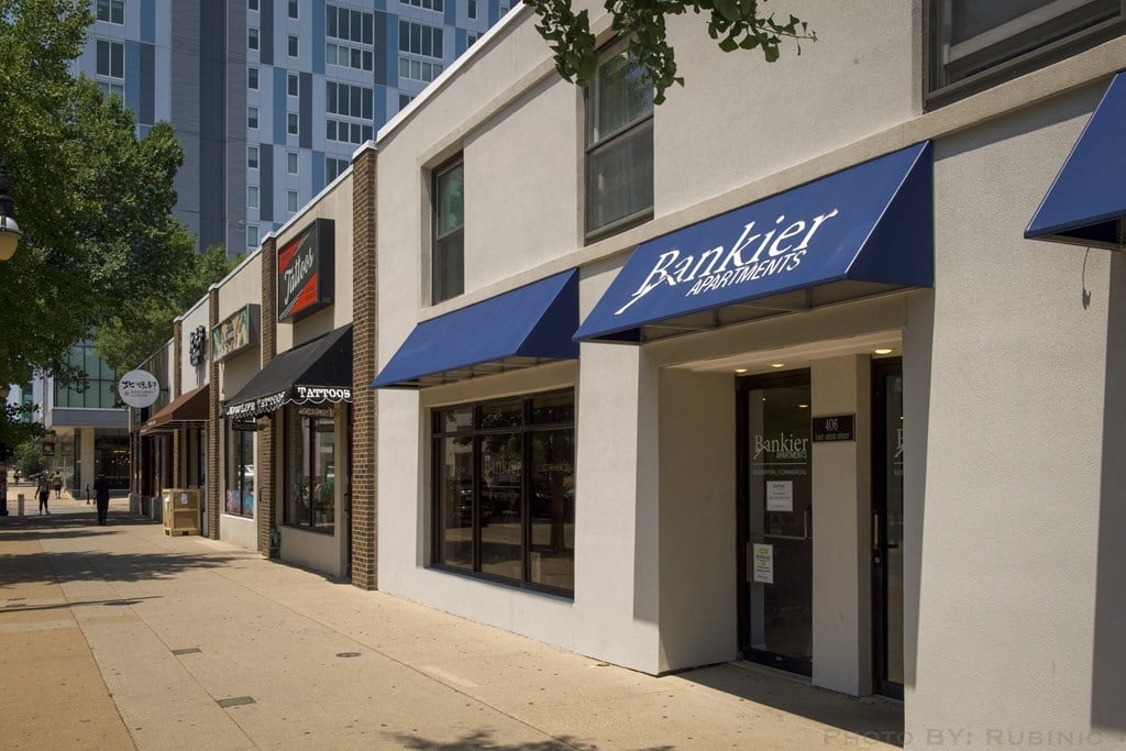 a row of restaurants with blue awnings on a sidewalk