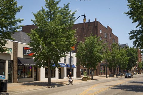 a man riding a bike down a street