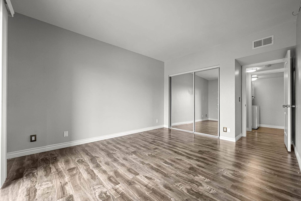 A room with wooden flooring and a sliding door at Lafayette Apartments, California