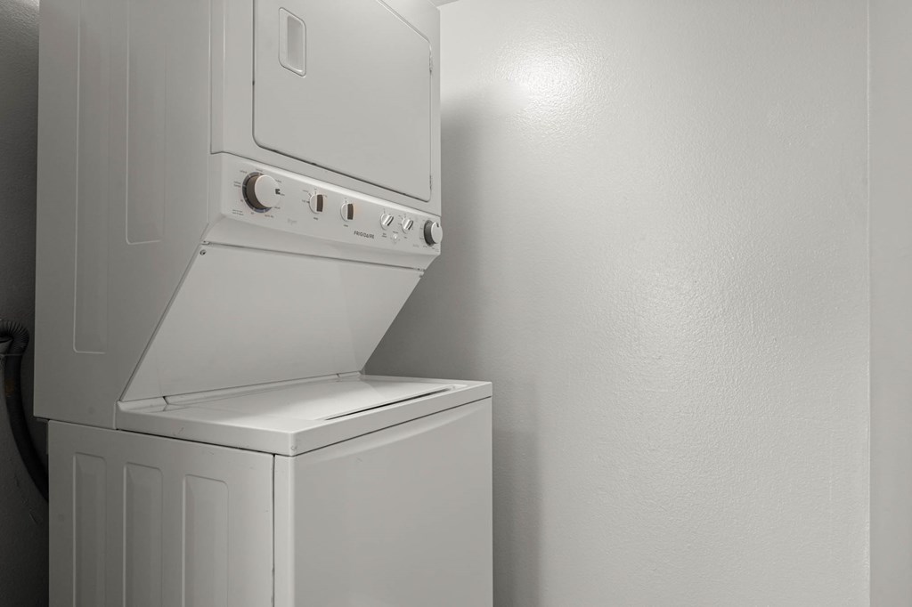 A white oven with a hood is mounted on a wall at Lafayette Apartments, Los Angeles, California