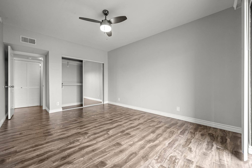 A room with a ceiling fan and wood flooring at Lafayette Apartments, Los Angeles 90019