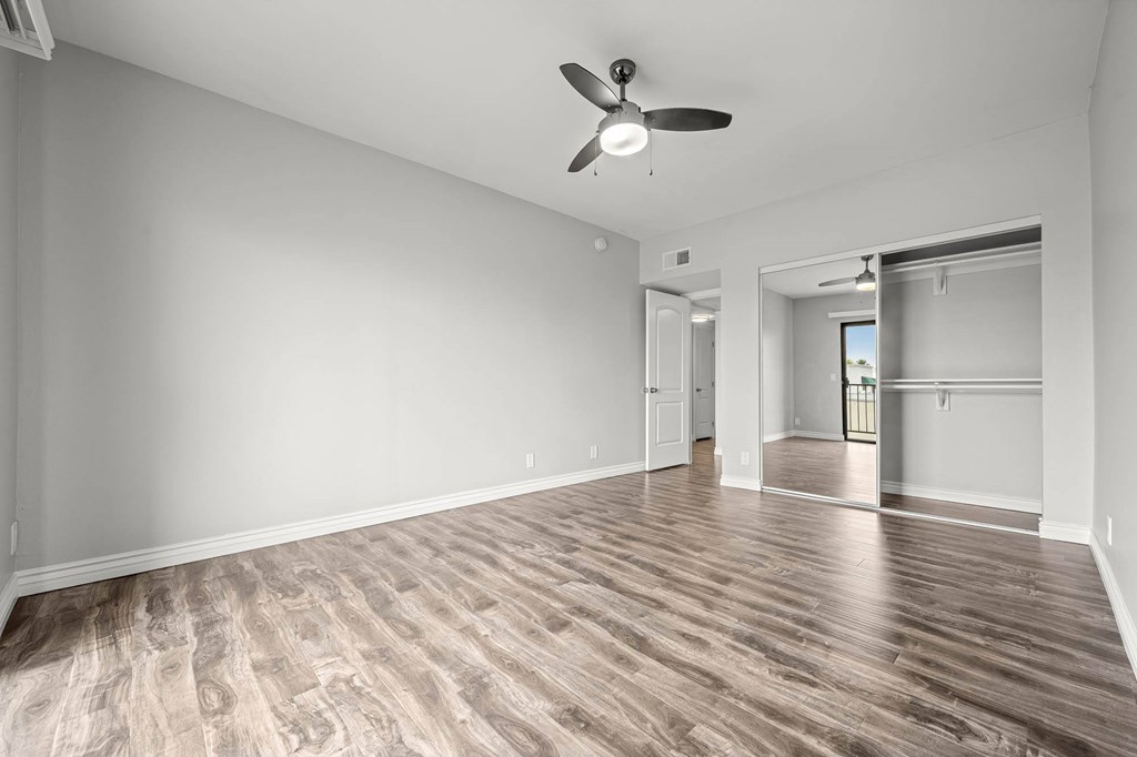 A room with a ceiling fan and wooden flooring at Lafayette Apartments, California, 90019
