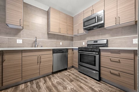 A kitchen with wooden cabinets and black appliances.