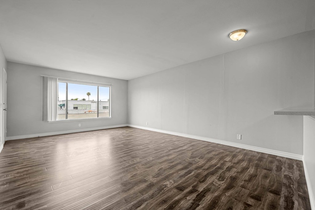 Empty room with wooden flooring and a window at Lafayette Apartments, California