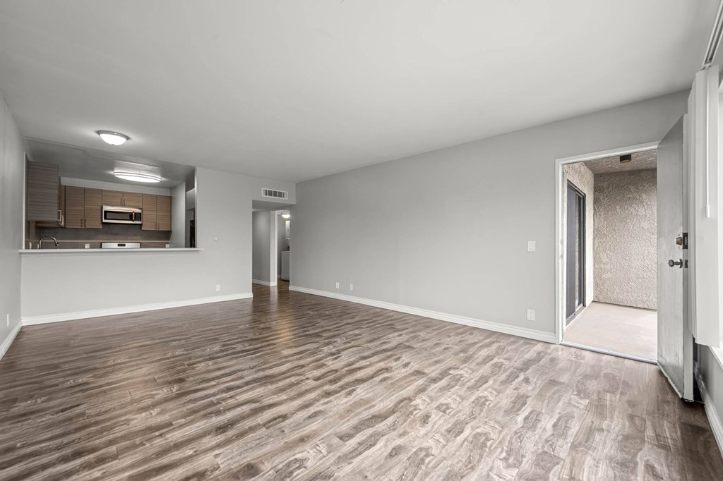 A room with wooden flooring and white walls at Lafayette Apartments, Los Angeles