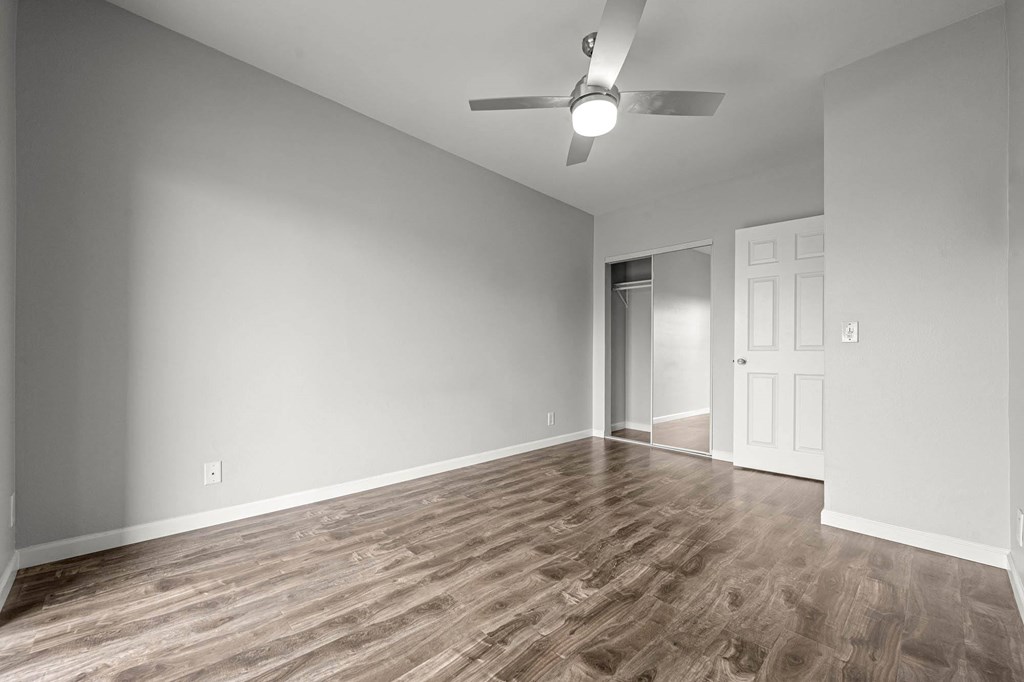 A room with a ceiling fan and wooden flooring at Lafayette Apartments, Los Angeles, CA, 90019