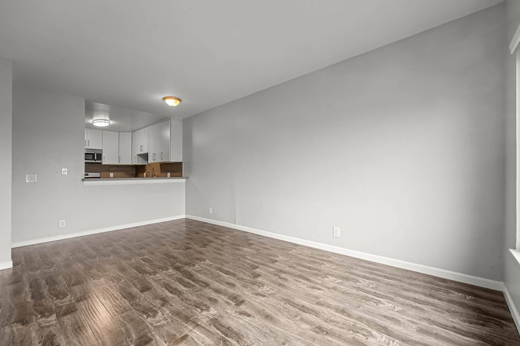 A room with a wooden floor and white walls at Lafayette Apartments, Los Angeles, California