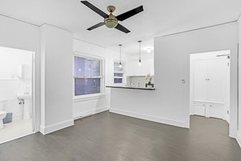 A spacious room with a ceiling fan and a window.