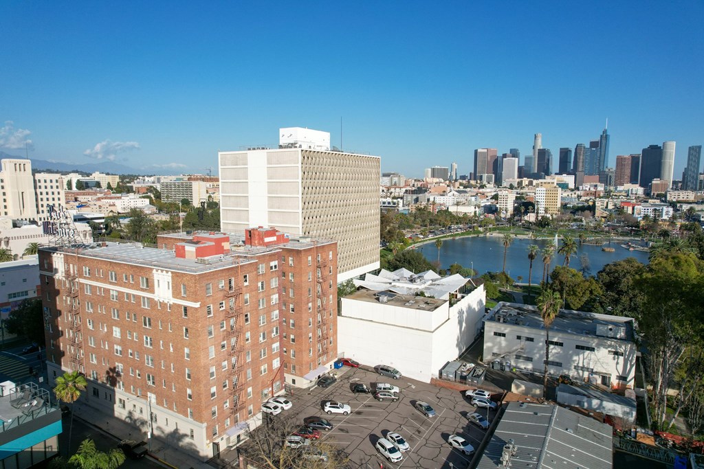 A large red brick building with a white building in front of it.