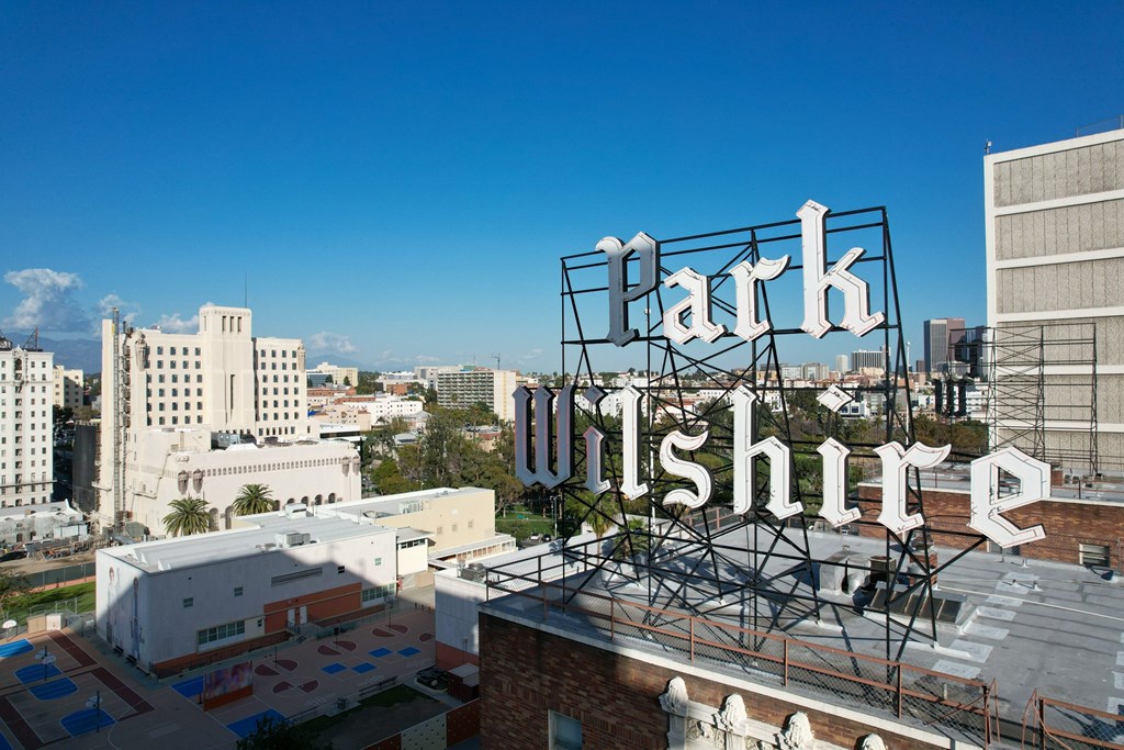 A large sign that says Parkshire is in front of a city skyline.