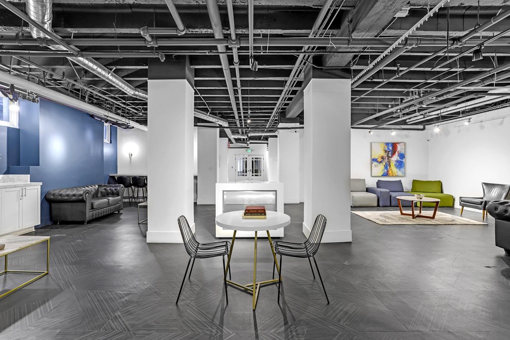 A room with a table and chairs in the center.