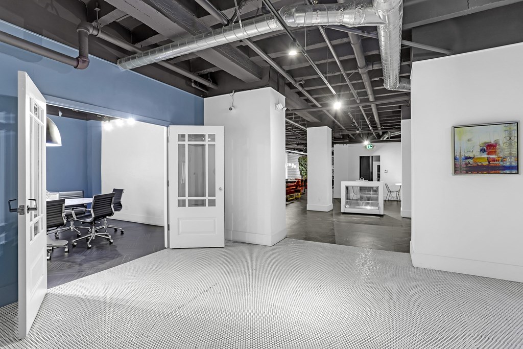 A room with a white floor and a white door.