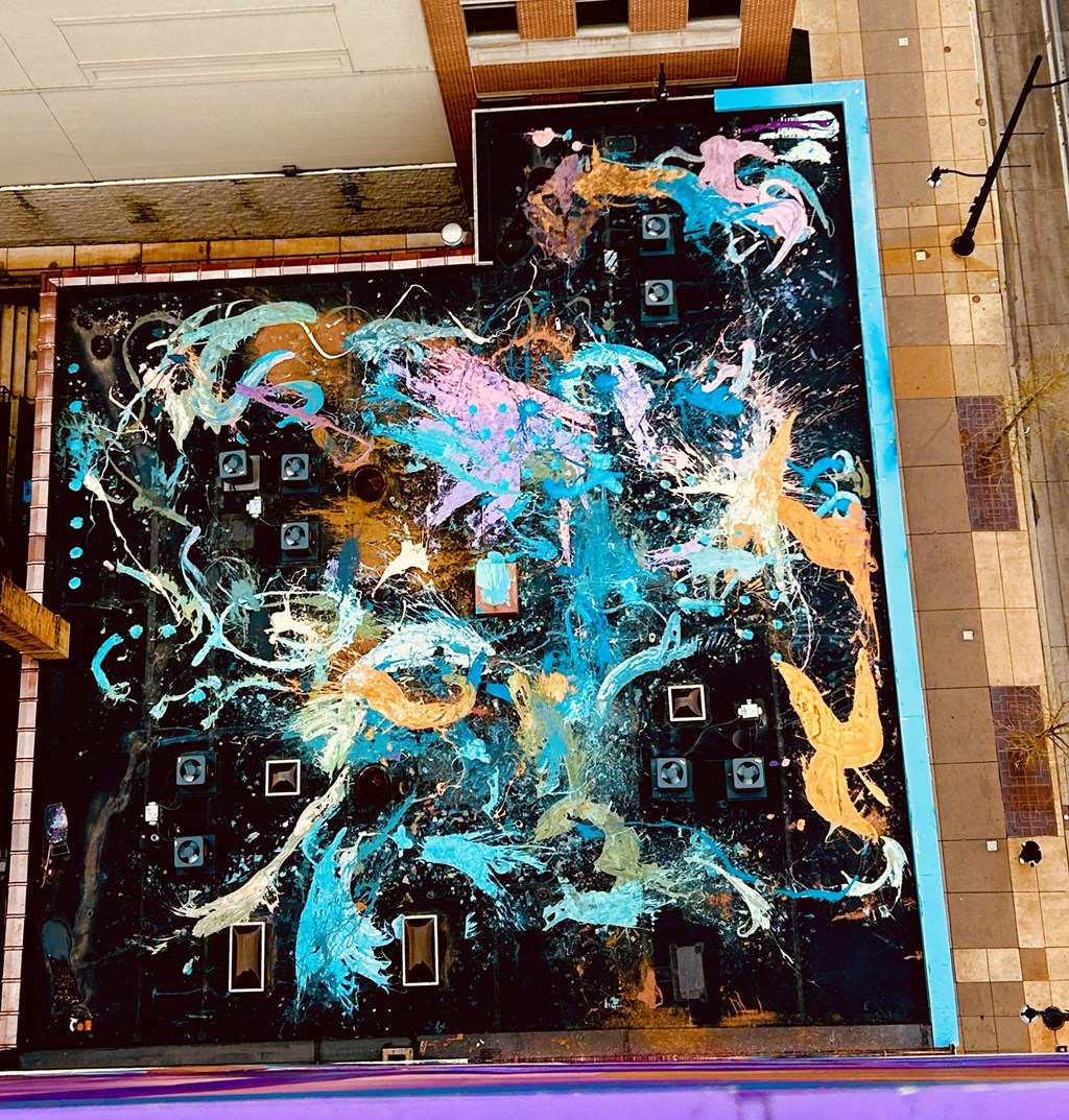 a large painting on a wall in a building