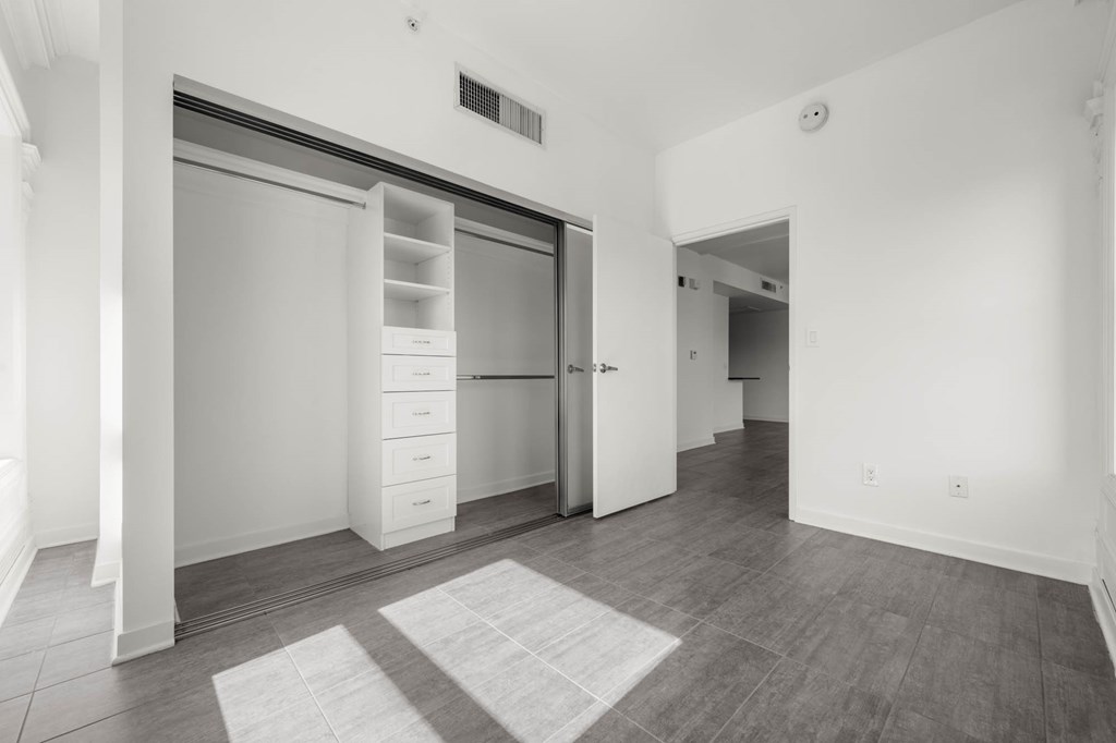 Bedroom with closet at Grand Central Market Apartments, Los Angeles, CA