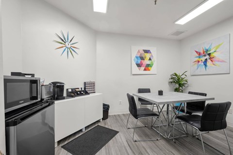 A modern kitchen with a dining table and chairs.