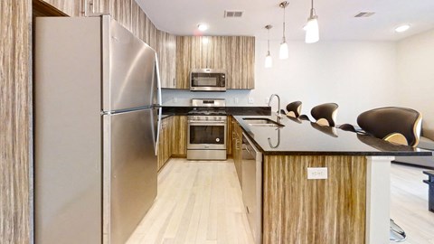 a kitchen with stainless steel appliances and a counter top