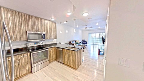 a kitchen with wooden cabinets and stainless steel appliances