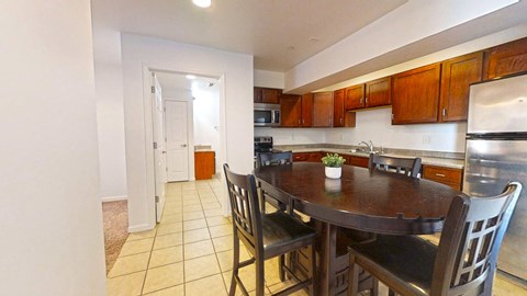 a kitchen with a wooden table and chairs
